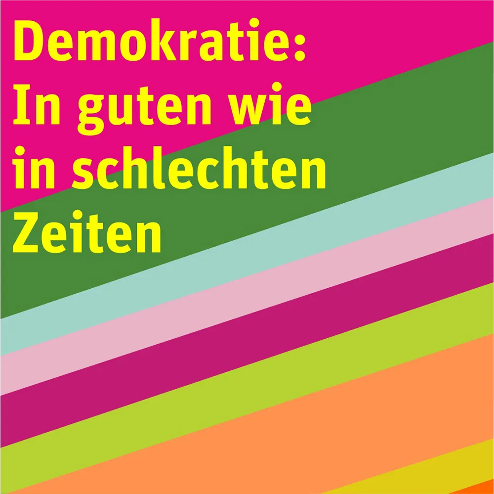 Menschen zeigen ein Banner mit dem Text: Demokratie in guten wie in schlechten Zeiten